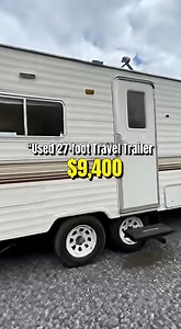 used 27-foot travel trailer listed for $9,400 From the outside, the trailer shows expected wear for its age, but the siding looks straight, the unit sits level, and the roof line appears even. Inside, the flooring feels solid near the entry, which is an important check on older travel trailers. The living area feels wider than expected, with enough space for basic seating and movement. The kitchen setup is older, with cabinets that show wear, but everything functions properly. Plumbing works, an